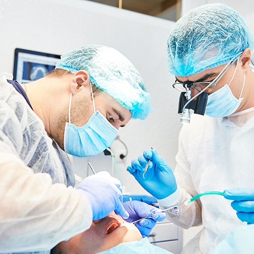 Dental implant team carefully working on patient