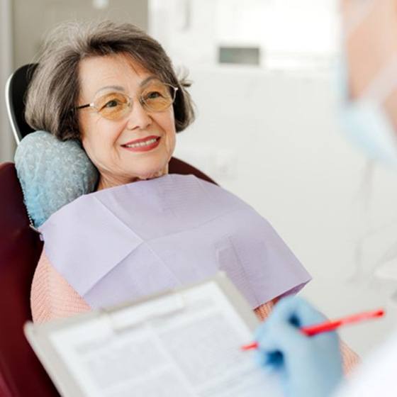 Dentist taking notes during patient consultation