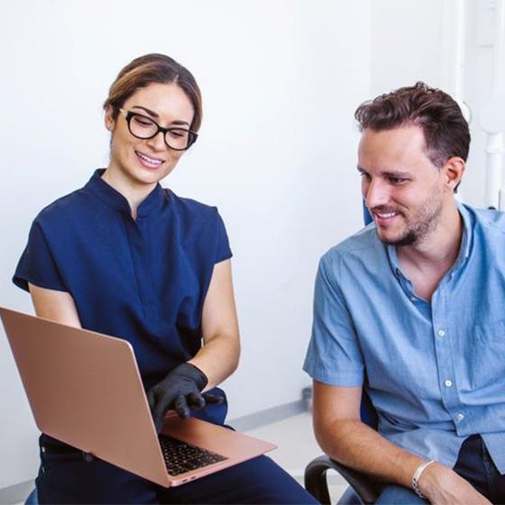 Dentist and patient looking at computer together