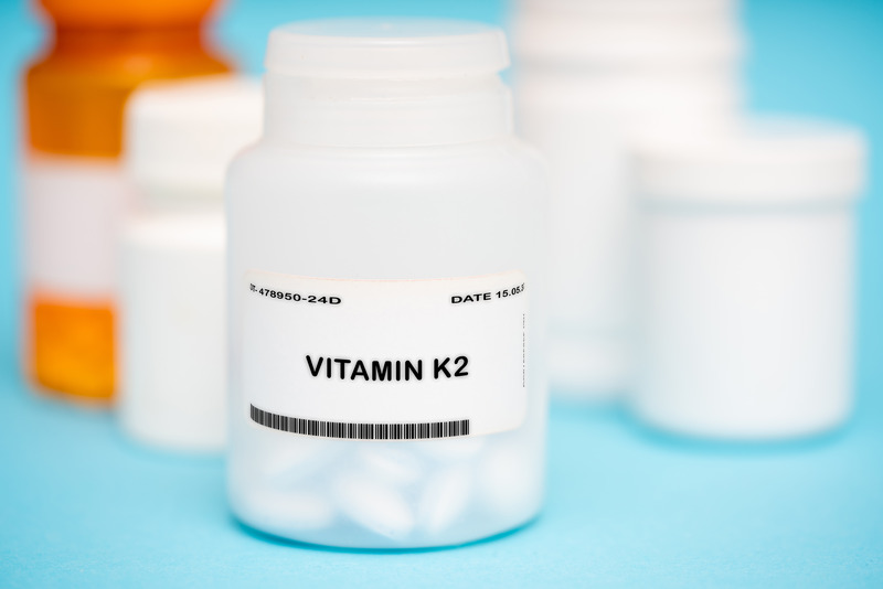 A bottle of vitamin K2 that supports stronger jawbones